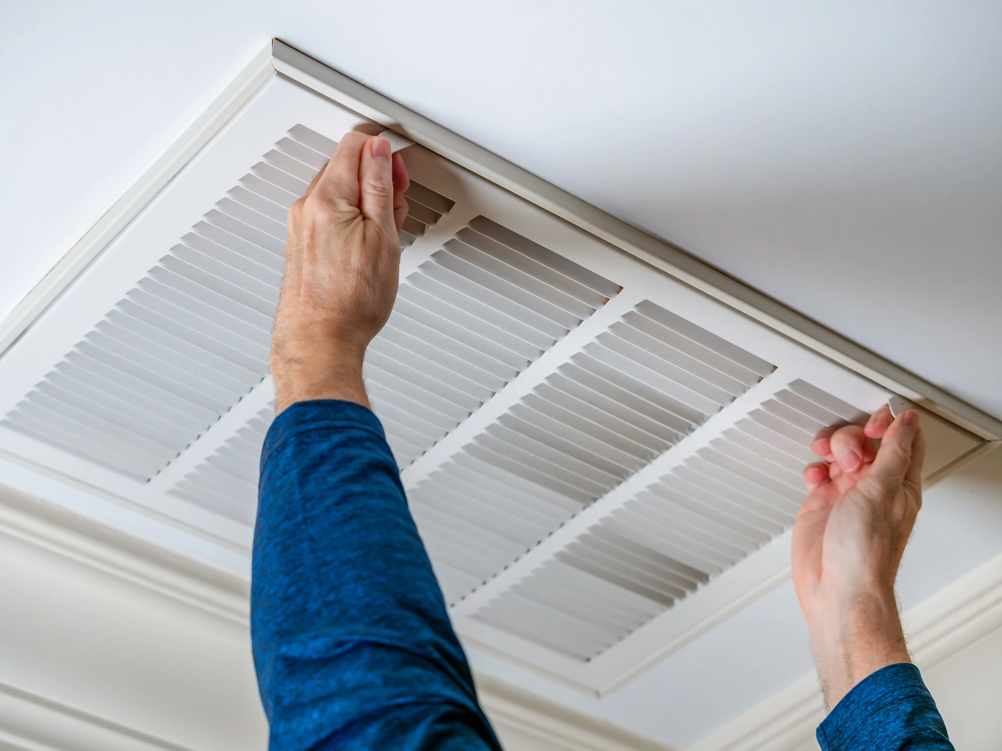 Technician removing dirty air filter and replacing it. 