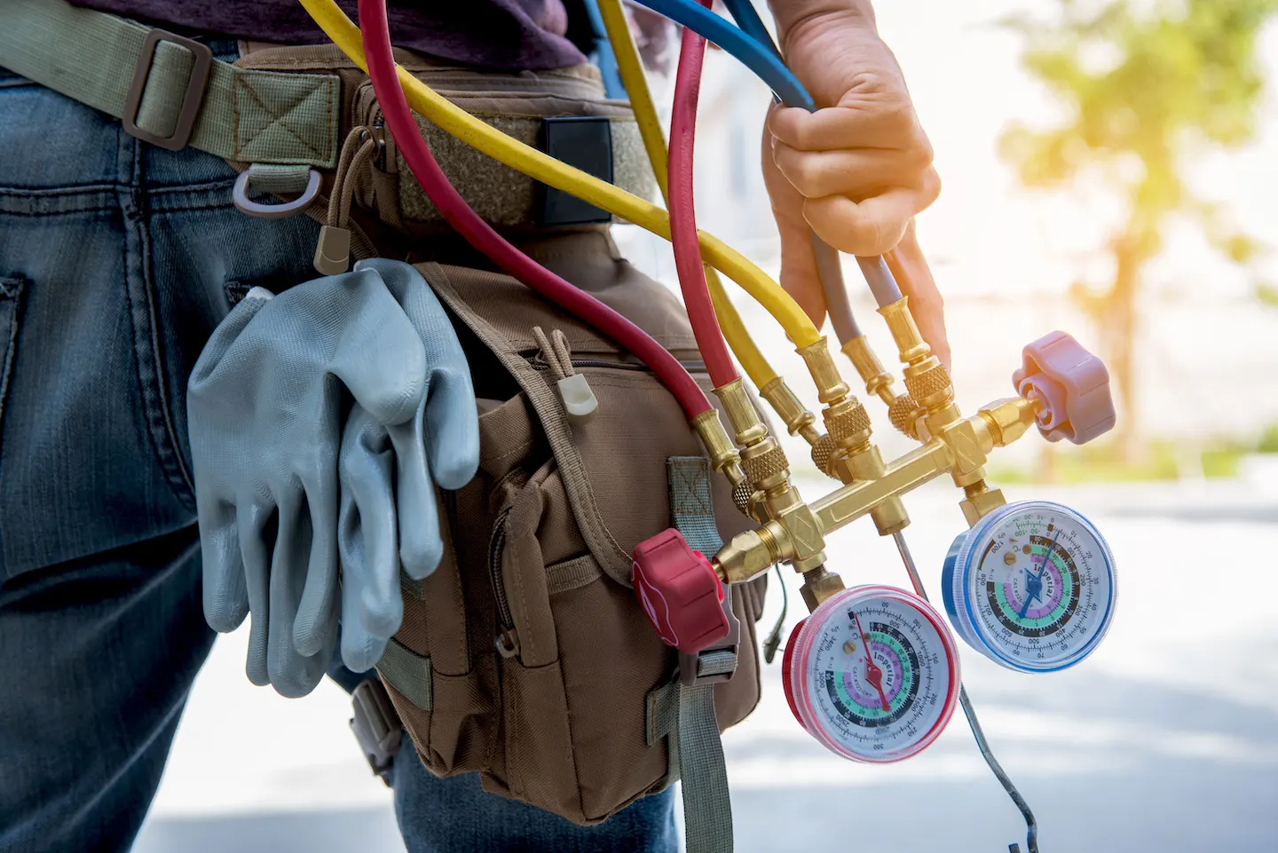 TemperaturePro Columbus technician holding pressure gauge for AC repair.
