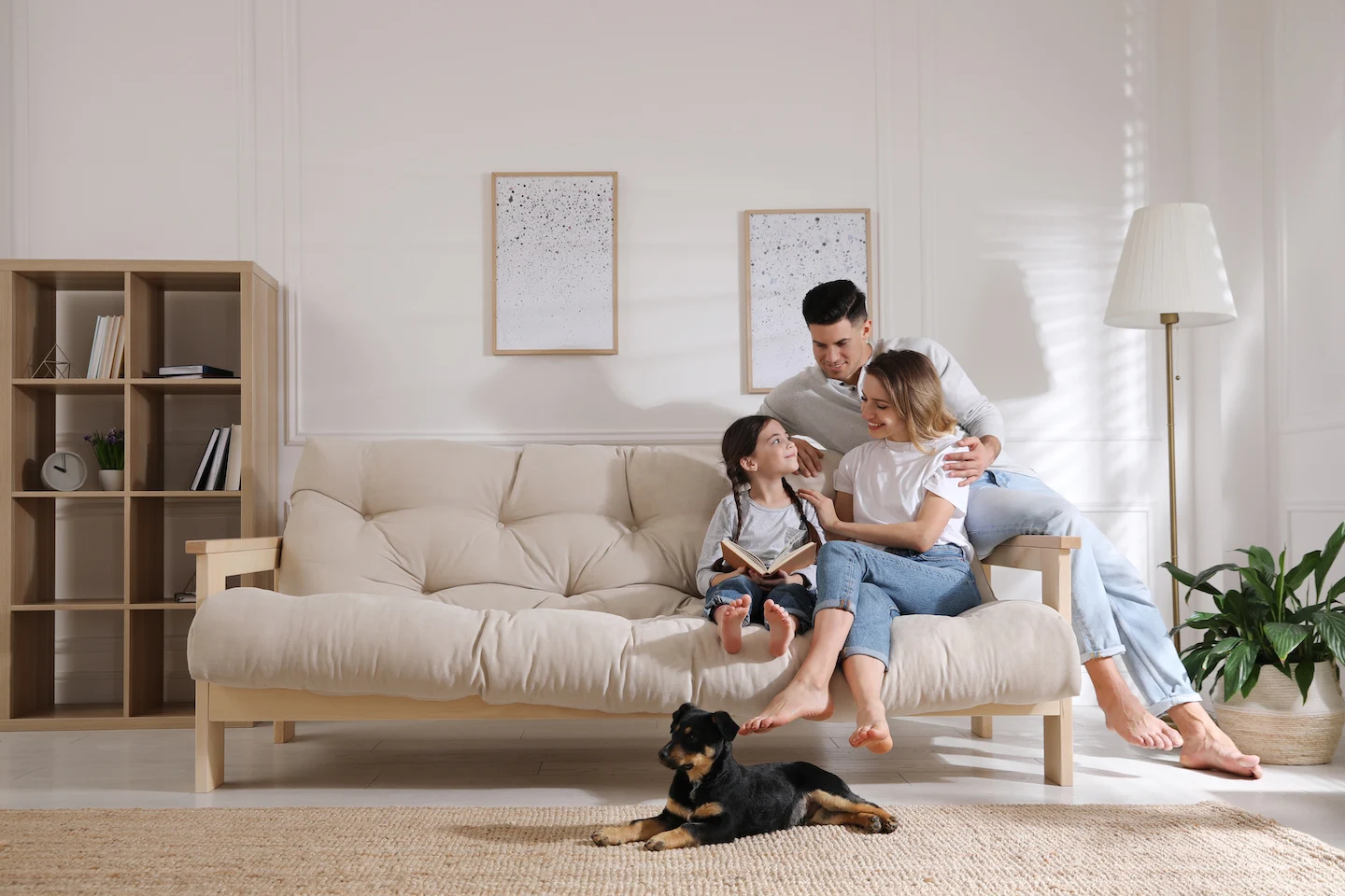 Comfortable family sitting on couch with dog in home in Columbus.